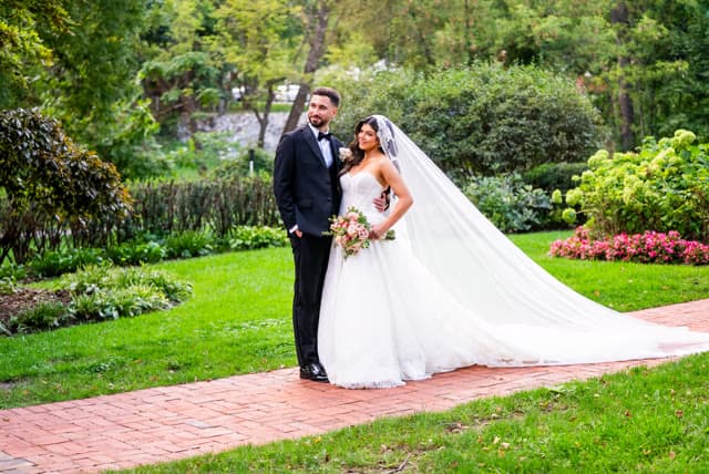 Bride and groom portrait on the garden path.