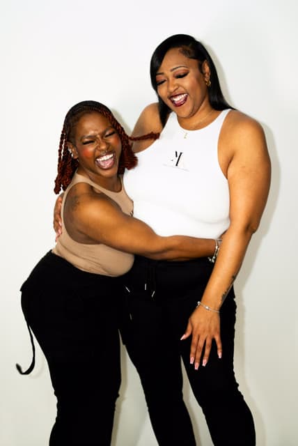 Behind-the-scenes, two clients laughing together.