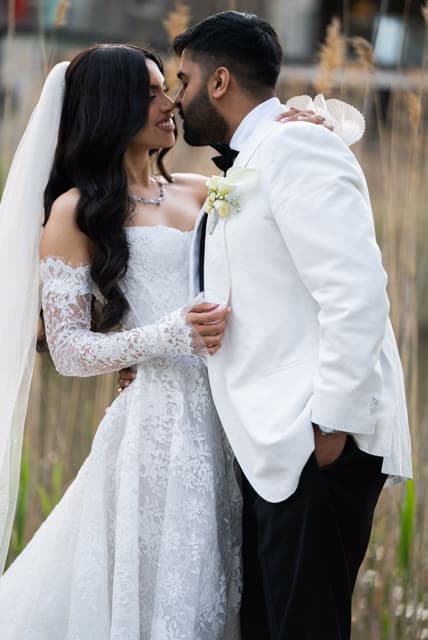Bride and groom, close portrait among the reeds.