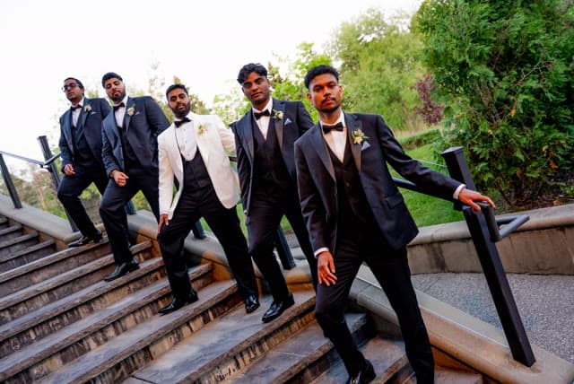 Groomsmen descending a staircase.